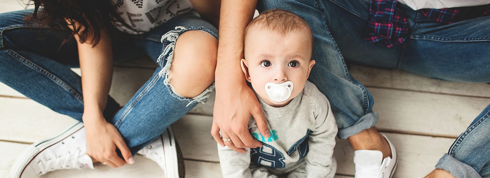 Header-Family-with-Baby-on-Floor