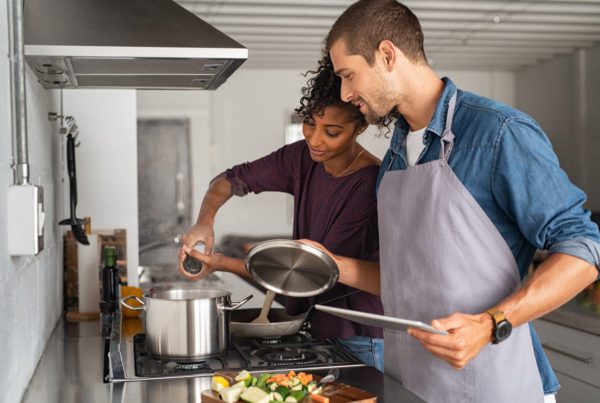 Blog - Woman adding salt in pot while cooking