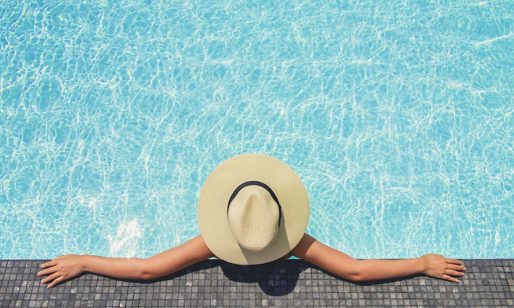 Carefree woman relaxation in swimming pool summer Holiday concept