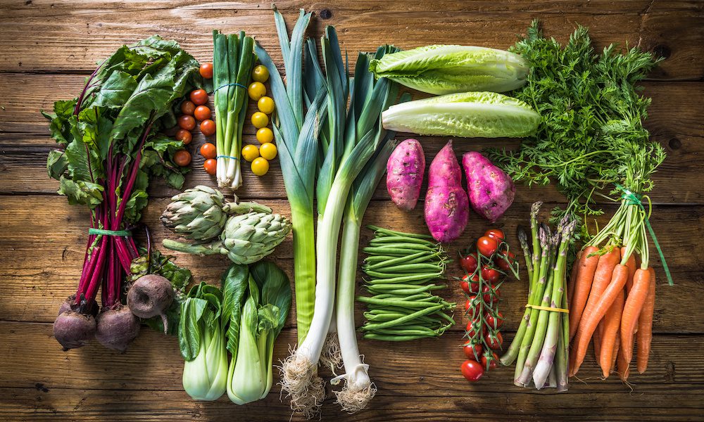 table filled with fresh vegetable produce