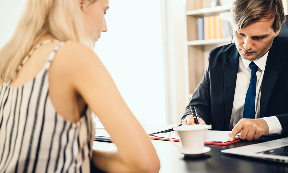 Blog - Professional Discussing Fraud Portection in the Office with a Client